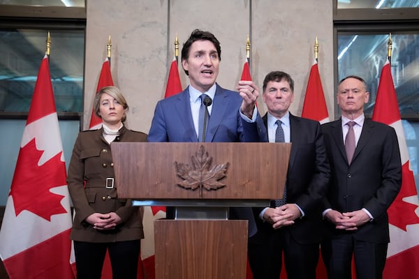 Prime Minister Justin Trudeau holds a news conference on imposed U.S. tariffs as Foreign Affairs Minister Melanie Joly, Finance Minister Dominic LeBlanc and Public Safety Minister David McGuinty look on in Ottawa on Tuesday, March 4, 2025. (Adrian Wyld /The Canadian Press via AP)