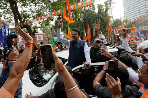 Deputy Chief Minister of Maharashtra, Devendra Fadnavis, center, raises a fist at the Bhartiya Janata Party office in Mumbai, India, Saturday, Nov 23, 2024.(AP Photo/Rajanish Kakade)