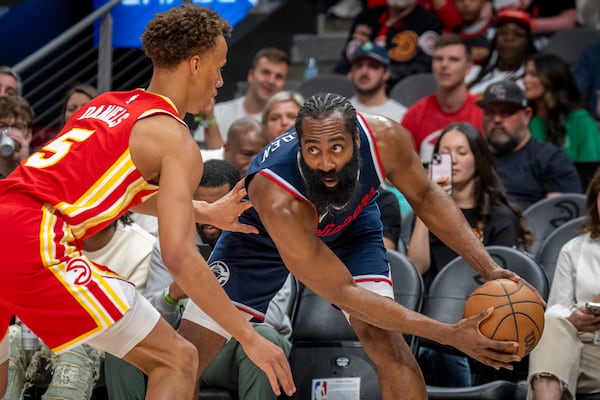 Los Angeles Clippers guard James Harden (1), right, attempts to pass the ball against Atlanta Hawks guard Dyson Daniels (5), left, during the first half of an NBA basketball game, Friday, March 14, 2025, in Atlanta. (AP Photo/Erik Rank)