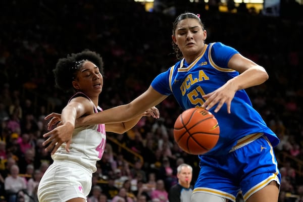 UCLA center Lauren Betts (51) grabs a rebound in front of Iowa forward Hannah Stuelke, left, during the second half of an NCAA college basketball game, Sunday, Feb. 23, 2025, in Iowa City, Iowa. (AP Photo/Charlie Neibergall)