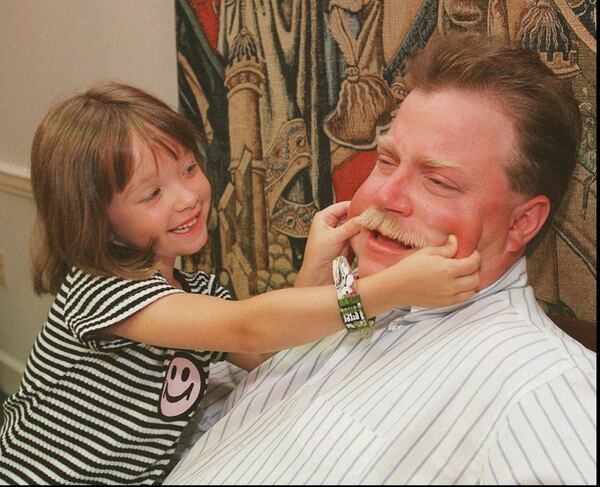 Richard Jewell’s god-daughter, six-year-old Heather Dutchess, plays as Jewell is interviewed about his experience as a suspect in the Centennial Olympic Park bombing in 1997. Jewell said during the interview that he was, ‘Sorry, I don’t have a (business) card that says ex-suspect.’ Jewell died of heart failure due to complications from diabetes in 2007. AP PHOTO / RIC FELD