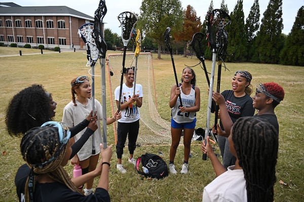 Members of the Spelman lacrosse team, clockwise from left, Kaitlin Britton Wheeler (midfielder), Laila Christian (goalie), Kyle Irwin (midfielder), Sedera Green (defender), Olivia Robinson (midfielder), Deanna Lindo (midfielder), Jamea Beavens (defender) and Natajha Graham (midfielder) cheer as they end their practice at Spelman College on Tuesday, Oct. 25, 2022, in Atlanta. (Hyosub Shin/The Atlanta Journal-Constitution/TNS)