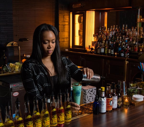 Kiara Tarber, a bartender at Golden Eagle, mixes a classic Blue Hawaiian cocktail. CONTRIBUTED BY HENRI HOLLIS