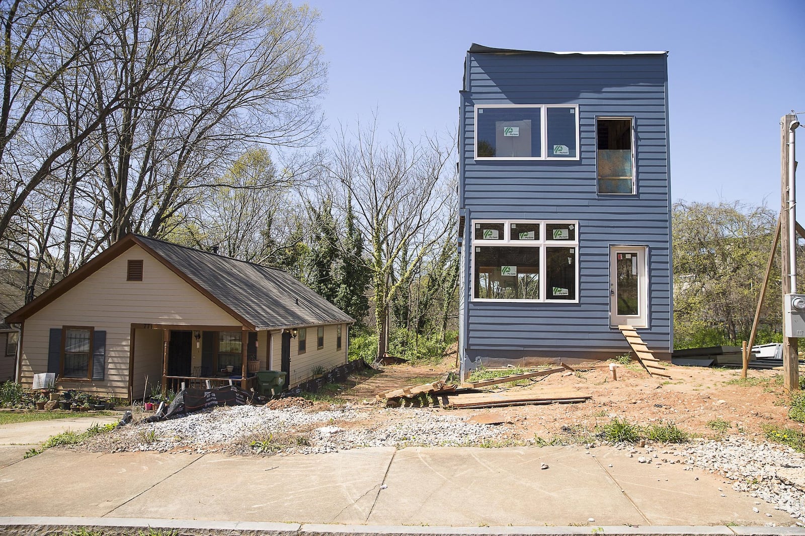 A newly developed house sits next to an older residence in the Summerhill community. 