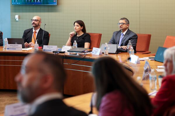 CDC Director Mandy Cohen, center, sits next to Demetre Daskalakis, Acting Director of the National Center for Immunization and Respiratory Diseases, left, and Nirav Shah, Principal Deputy Director of the CDC during a meeting with community leaders to discuss the new COVID vaccine rollout at the CDC, Thursday, September 14, 2023, in Atlanta. (Jason Getz / Jason.Getz@ajc.com)