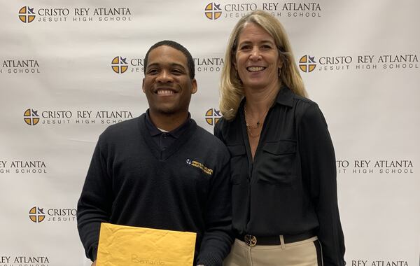 B.J. Little of Cristo Rey Atlanta Jesuit High School is congratulated by school President Camille Naughton for receiving an invitation to play in the 2022 PURE Insurance Championship at Pebble Beach.