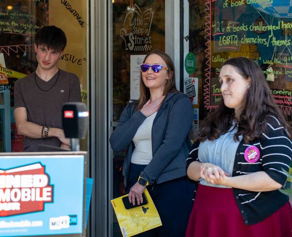 MoveOn Political Action's Banned Bookmobile is distributing free banned books at the kickoff of National Banned Book Week on Sunday, Oct 1, 2023 where speakers, including fired Cobb teacher Katie Rinderle, address concerns around book censorship in school libraries at Little Shop of Stories in Decatur Square.  Rinderle reacts to support from the group and the community.  (Jenni Girtman for The Atlanta Journal-Constitution)