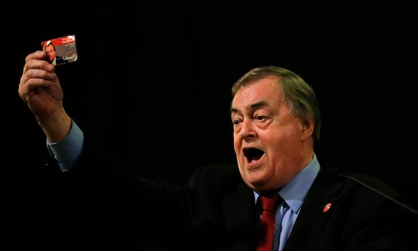 FILE -Former Deputy leader of the Britain's Labour Party, John Prescott, holds up his Labour Party membership card as he gives a speech at a campaign rally for Andy Burnham, the Labour party leadership hopeful, at the St Pancras Parish Church in London, Aug. 24, 2015. (AP Photo/Frank Augstein, File)