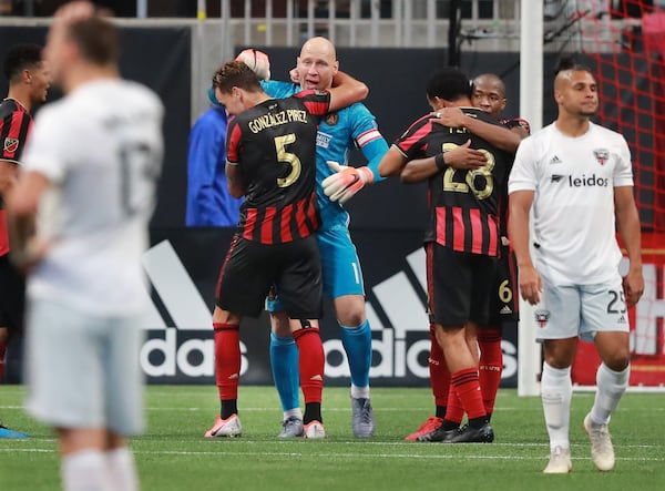 July 21, 2019 Atlanta: Atlanta United goalkeeper Brad Guzan and defender Leandro Gonzalez Pirez (from left) and Dion Pereira and Darlington Nagbe celebrate a 2-0 victory over D.C. United while Quincey Amarikwa walks away dejected as time expires in a soccer match on Sunday, July 21, 2019, in Atlanta.   Curtis Compton/ccompton@ajc.com