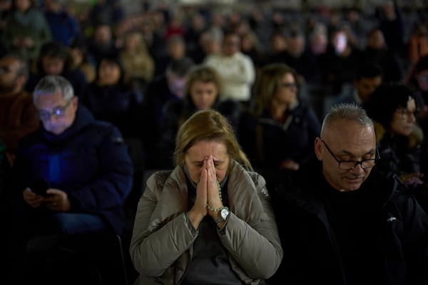 A woman prays as she joins with others for a prayer of the Rosary for Pope Francis in St. Peter's Square at The Vatican, Friday, March 7, 2025. (AP Photo/Francisco Seco)