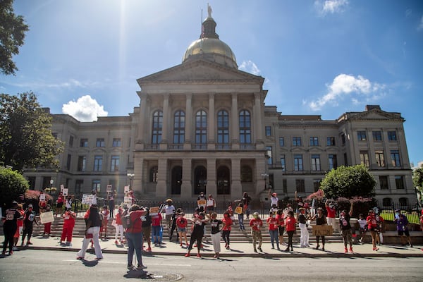 07/23/2020 - Atlanta, Georgia - Members of Delta Sigma Theta Sorority, Inc. and other supporters of Atlanta Mayor Keisha Lance Bottoms holds signs and chant outside of the Georgia State Capitol Building to stand in solidarity and support the Atlanta mayor, Thursday, July 23, 2020. Mayor Bottoms is a member of the Delta Sigma Theta Sorority. Gov. Brian Kemp issued a lawsuit against the Atlanta mayor due to her push to move her city back to phase 1 of reopening. (ALYSSA POINTER / ALYSSA.POINTER@AJC.COM)