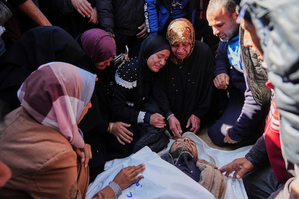 Mourners react next to the body of their relative Ahmed Al Shaer who was killed in the Israeli bombardment of the Gaza Strip as he brought for burial at Nasser Hospital in Khan Younis, Sunday, March 23, 2025. (AP Photo/Abdel Kareem Hana)