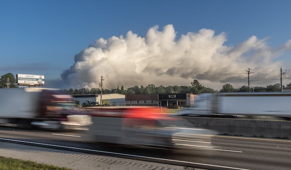 A large plume sits in the sky above Conyers on Monday Sept. 30, 2024 as I-20 reopened following the evacuation of about 17,000 people. Several metro Atlanta counties reported a haze and chemical smell Monday morning. A shelter-in-place order for all of Rockdale County has been extended indefinitely Monday. (John Spink/AJC)