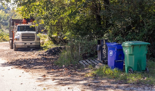 Stonecrest zoning has created several locations including Coffee Road where illegal dumping and overflow parking is adjacent to abandoned, overgrown homes Wednesday, Sept 29, 2021.  Some residential properties, like 1483 Coffee Road shown here, are occupied and are next to industrial operations. (Jenni Girtman for The Atlanta Journal-Constitution)