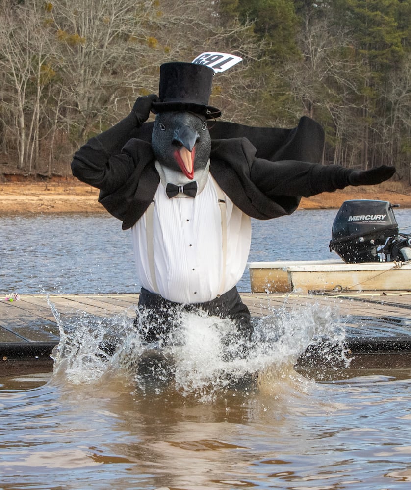 Long-time plunger, Tom Diaz comes as a penguin to the 26th annual Polar Bear Paddle and Plunge at Lake Lanier Olympic Park on Monday, Jan 1, 2024.  There is a category of best costume in the event, as well as best splash and fastest exit from the lake. (Jenni Girtman for The Atlanta Journal-Constitution)