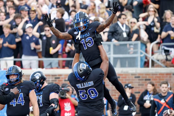 SMU wide receiver Roderick Daniels Jr. (13) celebrates after his touchdown reception with offensive lineman PJ Williams (59) during the first half of an NCAA college football game against Boston College in University Park, Texas, Saturday, Nov. 16, 2024. (AP Photo/Michael Ainsworth)