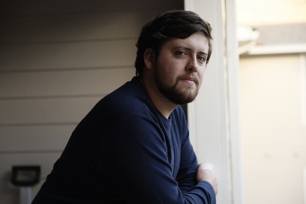 Third grade teacher Brandon Wyatt poses on the balcony of his house as he reflects on his first year at Ashford Park Elementary on Wednesday, Nov. 9, 2022. (Miguel Martinez / miguel.martinezjimenez@ajc.com)