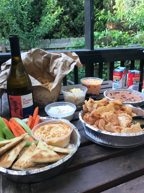 A snack pack ($31.93) from Local Three is a joy to unwrap. It contains fresh potato chips with a container of Vidalia onion dip; hummus with crudites and pita for dipping; barbecued pork rinds with a spicy-tangy pepper vinegar; a pint of pimento cheese; a container of Emily G’s jam to smear on a stash of butter crackers; and a big chocolate brownie with four individual milk containers. LIGAYA FIGUERAS / LIGAYA.FIGUERAS@AJC.COM