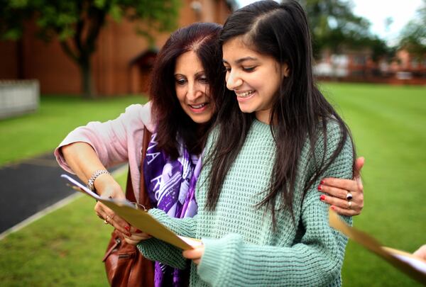 Withington Independent Girls School pupil Sophia Siddiqui, aged 18, is embraced by her mother Farzana Siddiqui as Sophia reveals that she achieved three A* and two A's in her A level exam results on August 15, 2013 in Manchester, England.