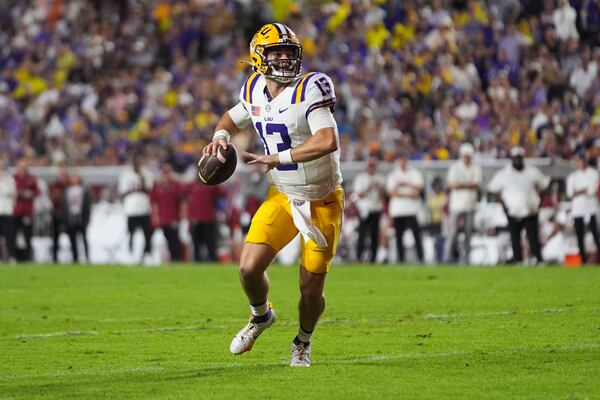 LSU quarterback Garrett Nussmeier (13) scrambles in the first half an NCAA college football game against Alabama in Baton Rouge, La., Saturday, Nov. 9, 2024. (AP Photo/Gerald Herbert)