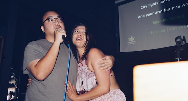 A couple performs a karaoke duet at Joystick Gamebar in Atlanta's Old Fourth Ward.