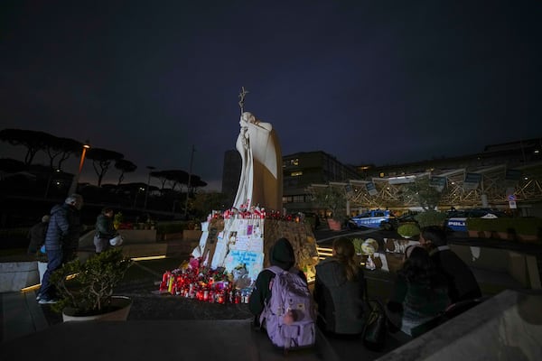 People pray for Pope Francis in front of the Agostino Gemelli Polyclinic, in Rome, Friday, March 7, 2025, where the Pontiff is hospitalized since Friday, Feb. 14. (AP Photo/Andrew Medichini)