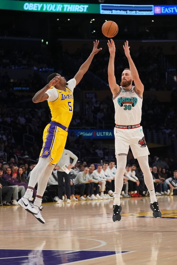 Memphis Grizzlies center Jay Huff (30) shoots over Los Angeles Lakers forward Cam Reddish (5) during the first half of an NBA basketball game Wednesday, Nov. 13, 2024, in Los Angeles. (AP Photo/Marcio Jose Sanchez)