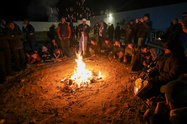 Families of Palestinian prisoners to be released from Israeli prison wait around a bonfire for their arrival in Khan Younis, southern Gaza Strip, late Wednesday Feb. 27, 2025. (AP Photo/Jehad Alshrafi)