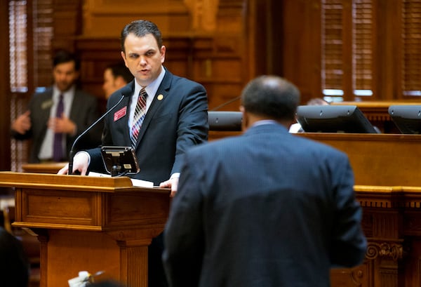 FILE - State Rep. Christian Coomer, R-Cartersville, left, answers a question from Rep. Al Williams, D-Midway, during a legislation debate on the House floor, March 25, 2015, in Atlanta. (AP Photo/David Goldman, File)