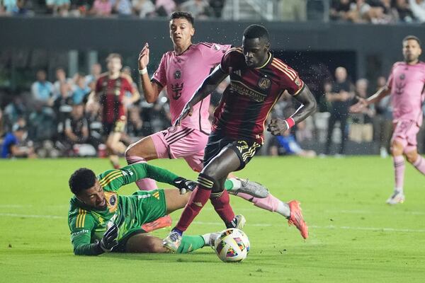 Inter Miami goalkeeper Drake Callender (1) defends Atlanta United forward Jamal ThiarÈ (29) during the first half of their MLS playoff opening round soccer match, Saturday, Nov. 9, 2024, in Fort Lauderdale, Fla. (AP Photo/Lynne Sladky)