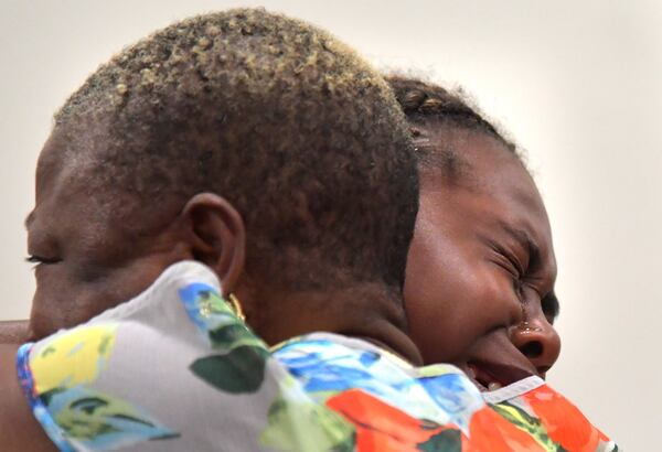  Family members of Timothy Coggins embrace after the murder trial of Franklin Gebhardt at the Spalding County Courthouse on Tuesday, June 26, 2018. A jury found the 60-year-old defendant - labeled a racist by his own lawyer - guilty on all counts for the 1983 crime. Gebhardt was charged with killing 23-year-old Timothy Coggins, stabbing him 30 times and dragging his body behind a pickup truck. 