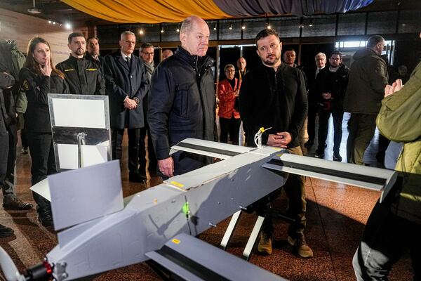 Ukraine's President Volodymyr Zelenskyy, right, and German Chancellor Olaf Scholz take a look at drones during Scholz's visit to Kyiv, Ukraine, Monday, Dec.2, 2024. (AP Photo/Efrem Lukatsky)