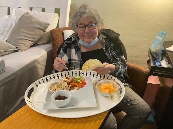 Susan Oliviero enjoys her first meal at home after being discharged from the hospital. (Helena Oliviero / helena.oliviero@ajc.com) 