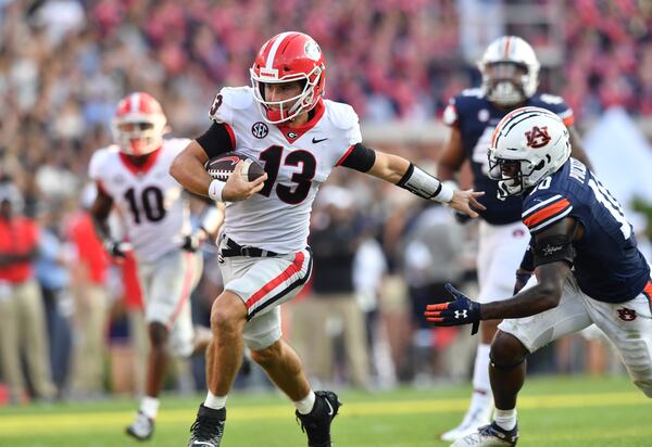 Georgia quarterback Stetson Bennett (13) runs with the ball against Auburn Saturday, Oct. 9, 2021, at Jordan–Hare Stadium in Auburn, Ala. (Hyosub Shin / Hyosub.Shin@ajc.com)