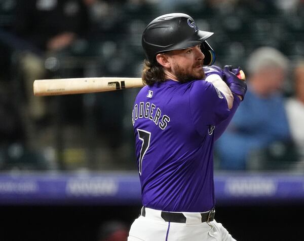 FILE - Colorado Rockies' Brendan Rodgers follows the flight of his RBI single in the eighth inning of a baseball game against the Arizona Diamondbacks, Sept. 17, 2024, in Denver. (AP Photo/David Zalubowski, File)