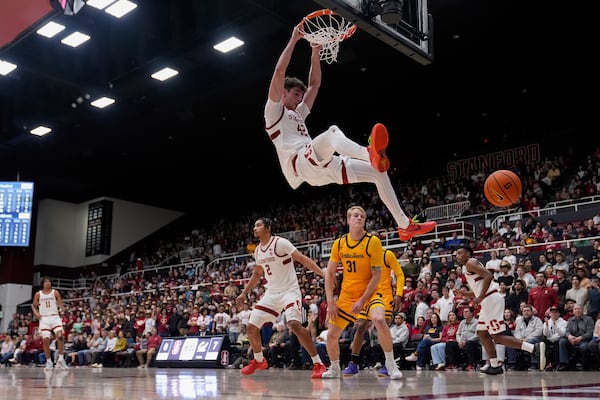 California forward Rytis Petraitis (31) watches as Stanford forward Maxime Raynaud (42) dunks during the first half of an NCAA college basketball game Saturday, Feb. 22, 2025, in Stanford, Calif. (AP Photo/Godofredo A. Vásquez)