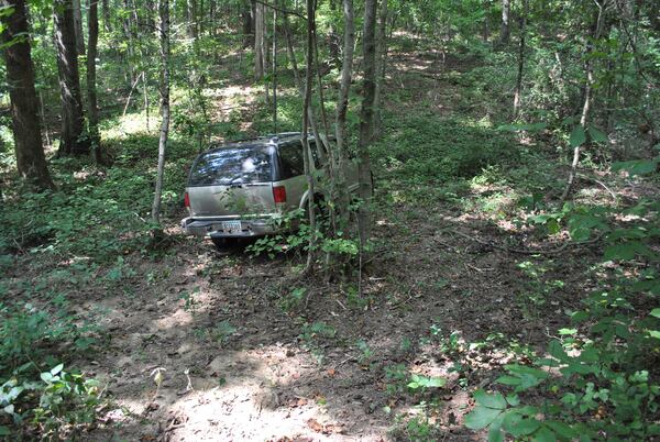 After firing more than a dozen shots at a Cherokee County deputy and leading police on a high-speed chase, Donaldson hid his SUV in some woods behind a Pickens County home.