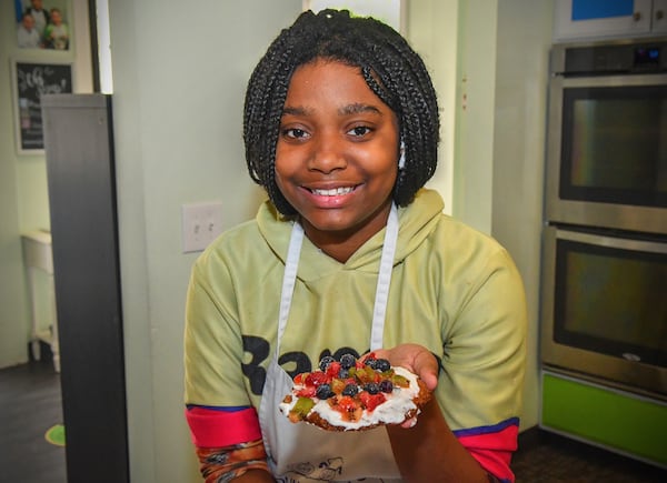 Sydney Sims, 12, of Atlanta shows the Oatmeal Cookie Crust she created during a recent class at Young Chefs Academy. Each student was given a number of toppings and food colorings to make their own version of this dessert. CONTRIBUTED BY CHRIS HUNT PHOTOGRAPHY