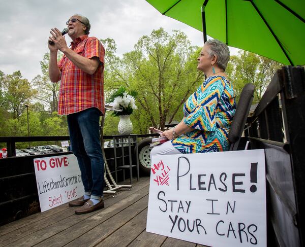 Pastor Shell Osbon and his wife Missy, talk to the crowd during the Drive-in church service at the Life Church Smyrna Assembly of God Sunday, April 5, 2020. STEVE SCHAEFER / SPECIAL TO THE AJC