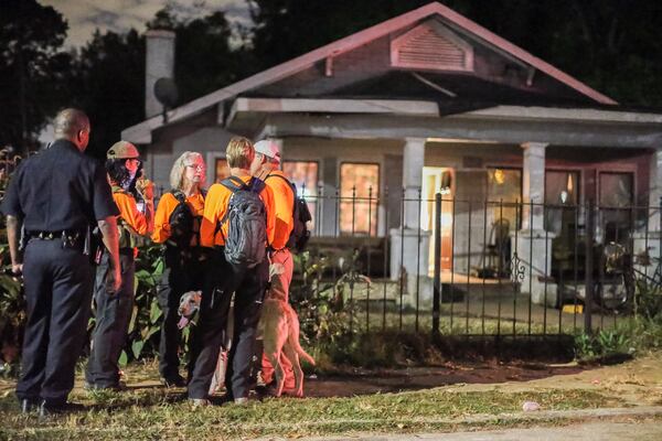 Local and federal investigators early Thursday searched for a missing 11-month-old Atlanta boy. A woman found him in a wooded area in southwest Atlanta in a T-shirt and wet diaper. JOHN SPINK / JSPINK@AJC.COM