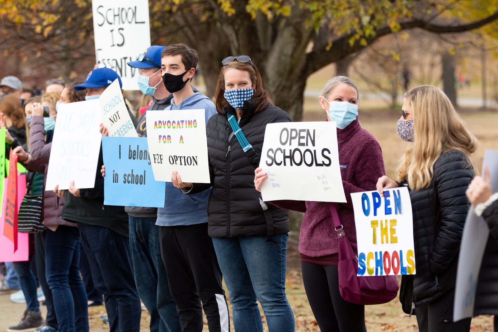 Parents and their children line along 10th Street N.E. near Piedmont Park on  Sunday, December 6, 2020, during a rally calling for the safe, immediate opening of Atlanta and DeKalb County schools. (Photo: Steve Schaefer for The Atlanta Journal-Constitution)