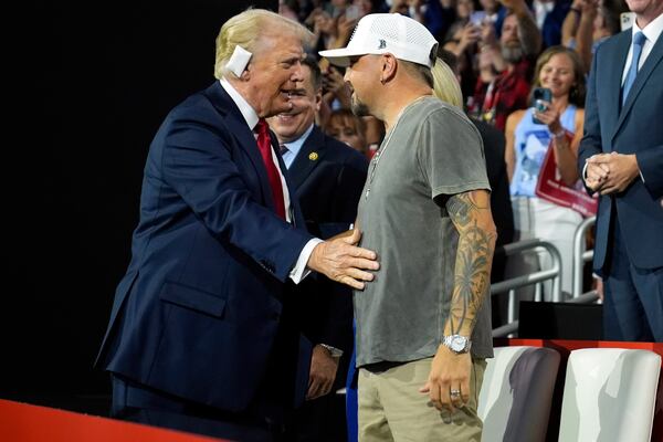 Former President Donald Trump, the Republican presidential candidate, greets country music singer Jason Aldean on the final day of the Republican National Convention in Milwaukee. Aldean, a native of Macon, has stumped in Georgia for the GOP. (Evan Vucci/AP)