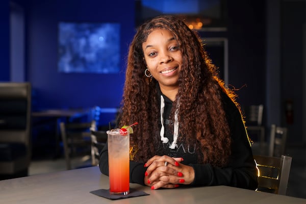 Nouveau Bar & Grill owner Ebony Austin at her restaurant in College Park. (Jason Getz / Jason.Getz@ajc.com)
