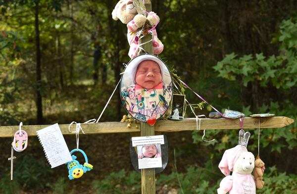 October 13, 2017 Covington - A memorial of flowers and letters is near the area where the newborn's body was found in Covington on Friday, October 13, 2017. Christopher McNabb is accused of killing his 15-day-old newborn inside the home by striking her in the head, according to investigators. Then, he allegedly wrapped her in a blanket and T-shirt, put her in a bag and attempted to hide her under debris, arrest warrants said. McNabb was charged with her death just days after pleading for the baby's return. HYOSUB SHIN / HSHIN@AJC.COM