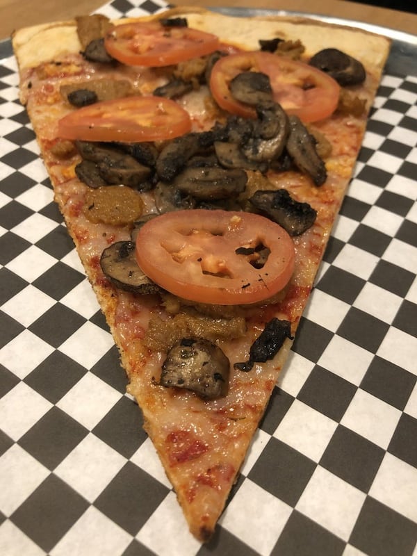 A vegan slice with mushroom, tomato and vegan sausage at Junior’s Pizza in Summerhill. CONTRIBUTED BY WENDELL BROCK