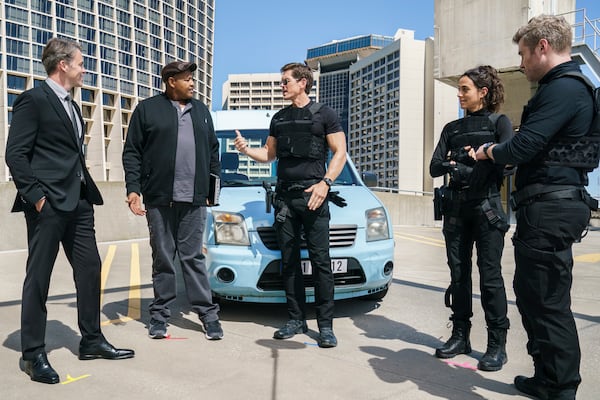 CBS's new drama "True Lies" is shot in Atlanta, which has to masquerade as a different city every episode. This backdrop is supposed to be Zurich, Switzerland, but any Atlantan familiar with downtown will recognize this skyline. Pictured L to R: Tom Connolly, Omar Miller as Gib, Steve Howey as Harry Tasker, Erica Hernandez as Maria, Mike O'Gorman as Luther. Photo: Jace Downs/CBS ©2022 CBS Broadcasting, Inc. All Rights Reserved.