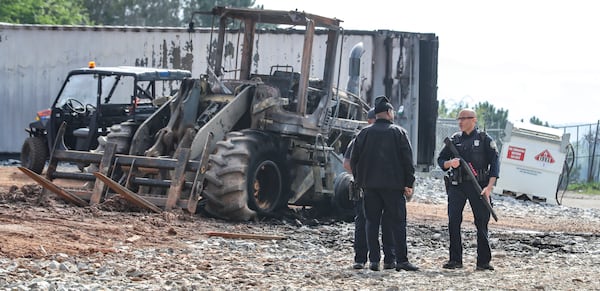 Atlanta police and construction personnel are on the construction site of the police training center March 6, 2023, in Atlanta examining equipment set on fire and destroyed by violent protests March 5. (John Spink / John.Spink@ajc.com)

