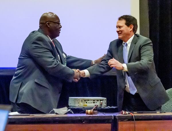 The reverend Abraham Mosley (L) is congratulated on being  the new chairman of the Stone Mountain Memorial Association at a meeting Monday at the Evergreen Conference Center at Stone Mountain Park STEVE SCHAEFER FOR THE ATLANTA JOURNAL-CONSTITUTION