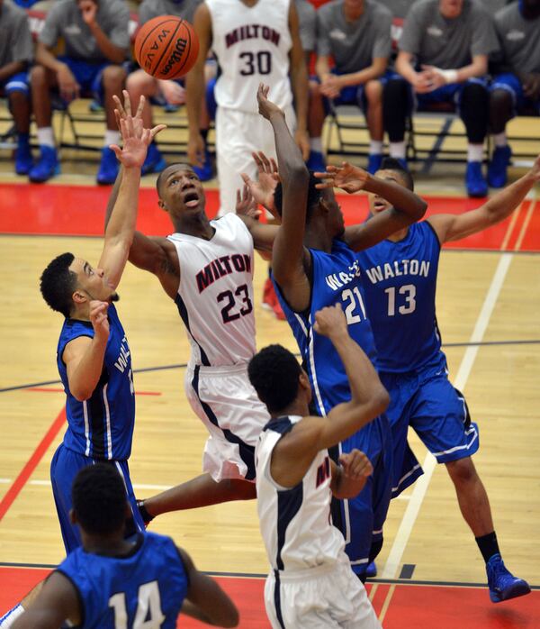 Milton's Chris Lewis reaches for a rebound against Walton High School on Friday, Jan. 10, 2014. Milton's Chris Lewis reaches for a rebound against Walton High School on Friday, Jan. 10, 2014.