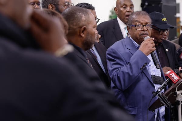 Surrounded by members of the community, Rev. Timothy McDonald speaks to the media about gun violence in Atlanta in 2022. Sunday he said  the nation is so divided and grounded in hatred that had Trump been killed, the nation would be torn apart.(Natrice Miller/natrice.miller@ajc.com)  